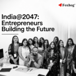 Group of diverse professionals posing in an office for India@2047: Entrepreneurs Building the Future (Foxhog logo in corner).