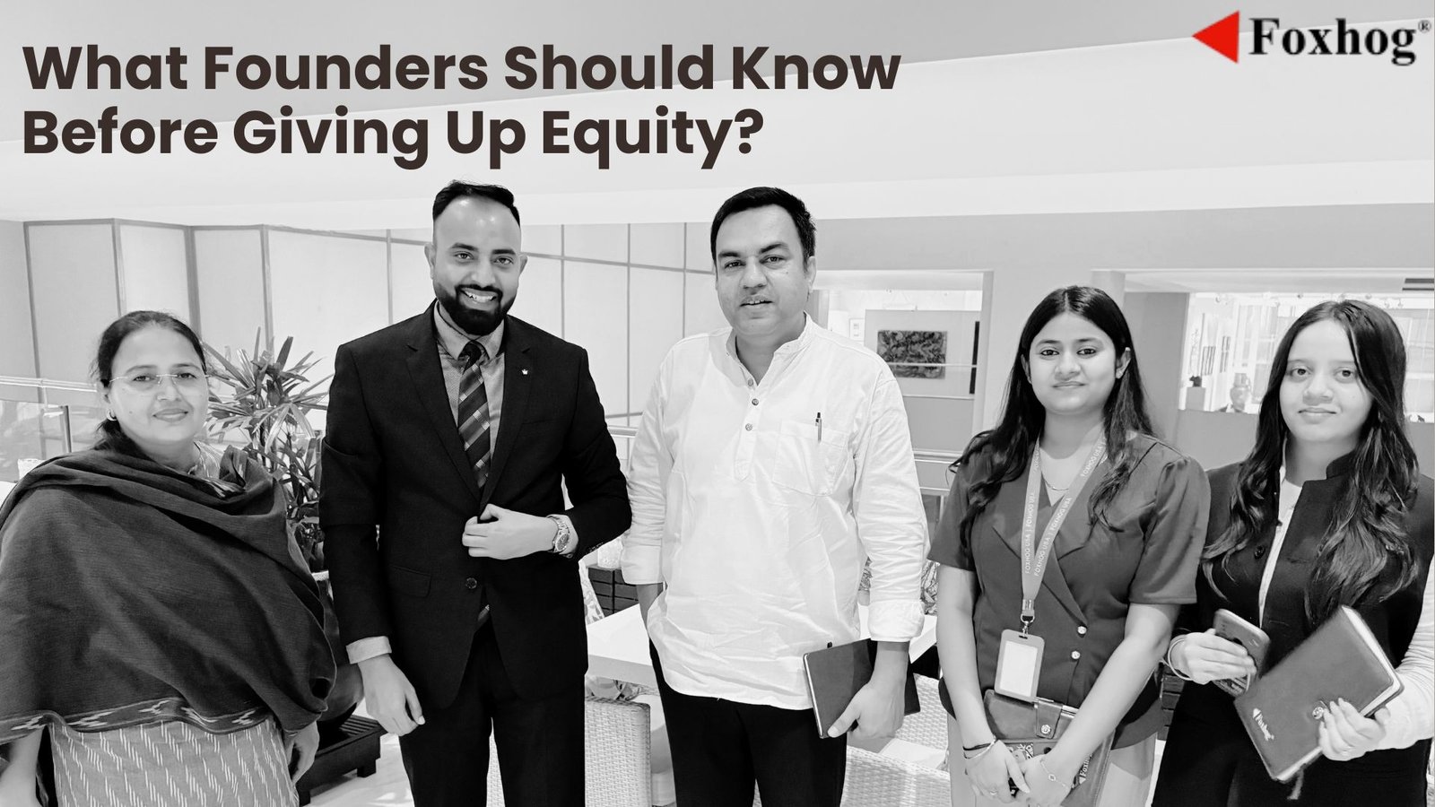 Five professionals in an office pose for a business article about founders' equity; Foxhog logo visible in the corner.