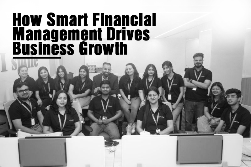Team of professionals in matching black shirts posing in an office for a feature on how smart financial management drives business growth.